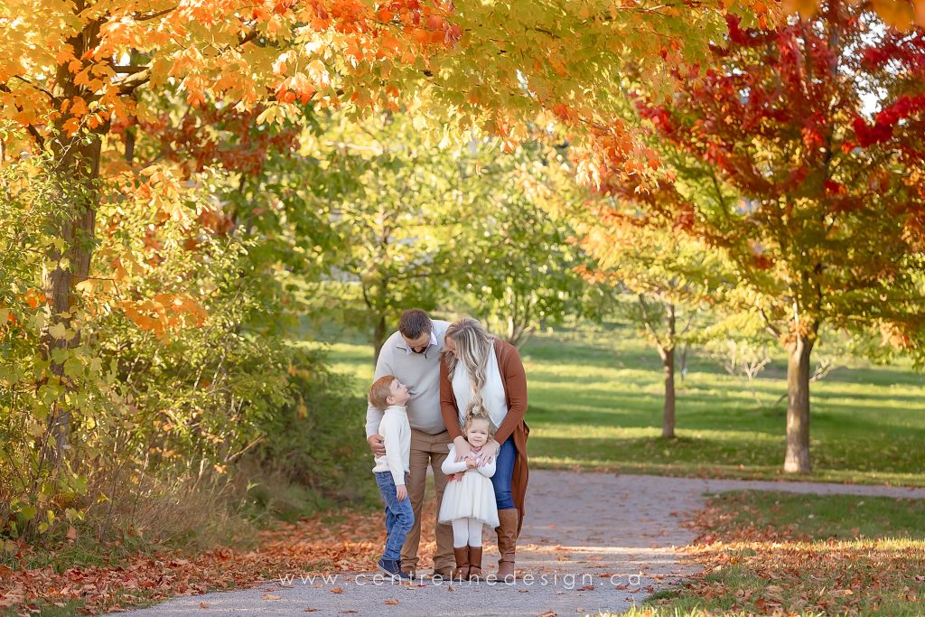 Family hugging in the fall colours