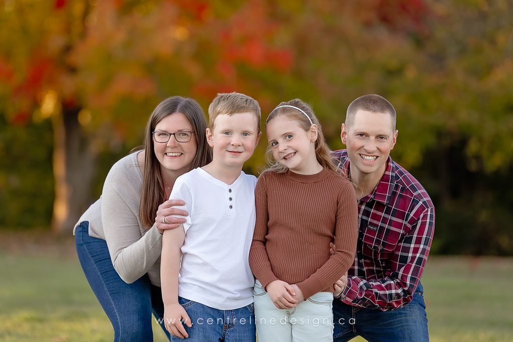 Family wearing cream, olive and rust outfits during a fall photography session in Kawartha Lakes.