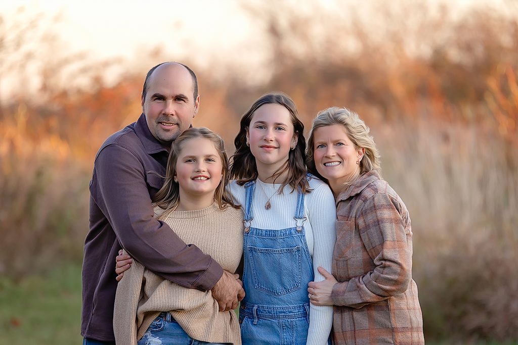 Family wearing cream, olive and rust outfits during a fall photography session in Kawartha Lakes.
